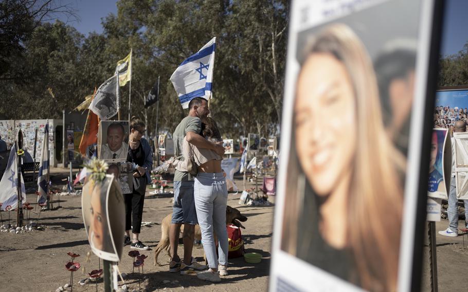 A family visits the the memorial marker of Bar Lior Nakmuli.