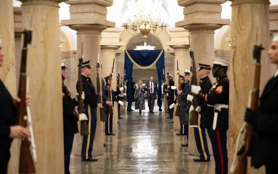 Service members stand at attention inside the Capitol.