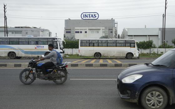 Commuters drive past the INTAS pharmaceutical manufacturing plant in Ahmedabad, India, Friday, Aug. 2, 2024, which had produced tainted eyedrops which sickened more than 80 Americans, killing four of them and blinding more than a dozen others. (AP Photo/Ajit Solanki)