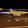 A Navy jet prepares to take off from an aircraft carrier.