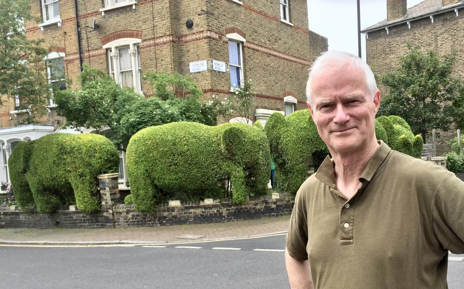 Tim Bushe with the elephant hedges in North London that he cut in 2012. His unique hedges have received the attention of both local and international media. These hedges in particular are also a Google Maps landmark, which now has a 4.7-star rating.