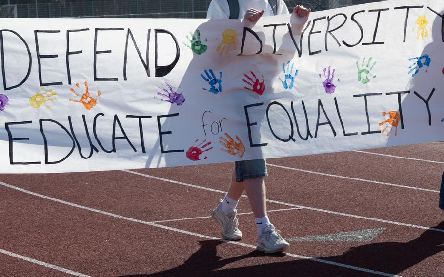 Students hold up protest signs