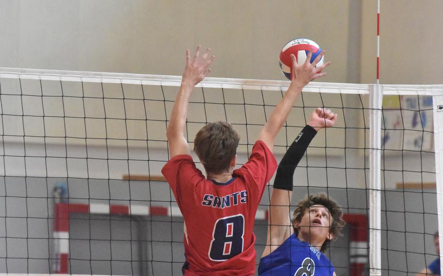 Rota’s Tyler DeMeritt watches his spike reach the block of Aviano’s Carl Greene during the Saints’ four-set victory over the Admirals on Saturday, Oct. 14, 2023.