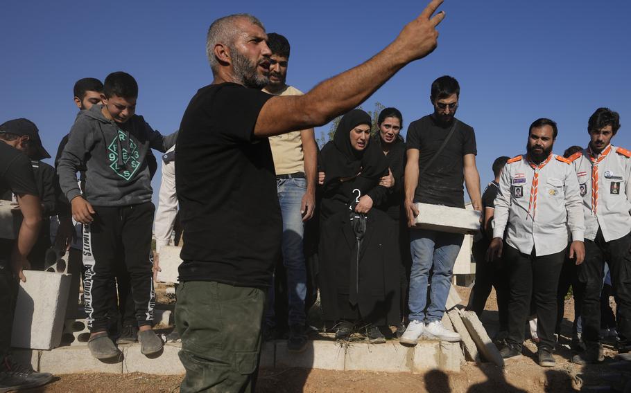 Mourners bury the bodies of their relatives, killed in Israeli airstrikes in the village of Karak, Bekaa Valley, eastern Lebanon.