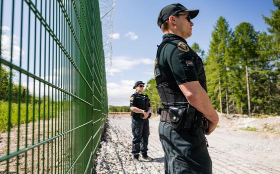 Finnish border guards at a section of the initial 3-kilometer (1.9-mile) stretch of fence under construction near a border crossing near Imatra, in southeast Finland, on May 30, 2023. MUST CREDIT: Roni Rekomaa/Bloomberg