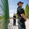 Finnish border guards at a section of the initial 3-kilometer (1.9-mile) stretch of fence under construction near a border crossing near Imatra, in southeast Finland, on May 30, 2023. MUST CREDIT: Roni Rekomaa/Bloomberg