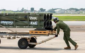 A U.S. Marine with Marine Medium Tiltrotor Squadron (VMM) 265, Marine Aircraft Group 36, 1st Marine Aircraft Wing moves M142 High Mobility Artillery Rocket System (HIMARS) ammunition pods onto an MV-22B Osprey at Marine Corps Air Station Futenma, Okinawa, Japan, May 8, 2024. VMM-265 transported the ammunition pods to test a new capability of resupplying a HIMARS. (U.S. Marine Corps video by Cpl. Daniel Avilaramirez)