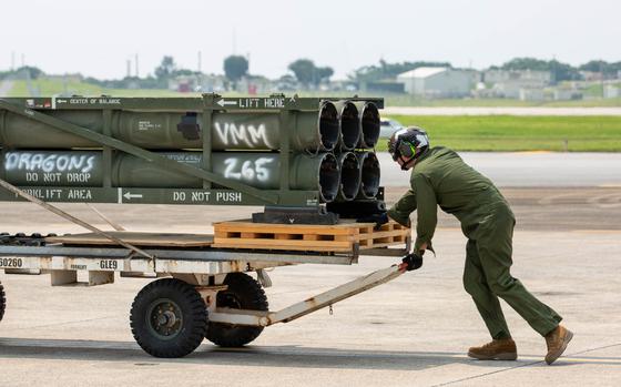 A U.S. Marine with Marine Medium Tiltrotor Squadron (VMM) 265, Marine Aircraft Group 36, 1st Marine Aircraft Wing moves M142 High Mobility Artillery Rocket System (HIMARS) ammunition pods onto an MV-22B Osprey at Marine Corps Air Station Futenma, Okinawa, Japan, May 8, 2024. VMM-265 transported the ammunition pods to test a new capability of resupplying a HIMARS. (U.S. Marine Corps video by Cpl. Daniel Avilaramirez)