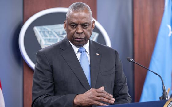 Lloyd Austin stands at a podium in front of the Pentagon emblem.