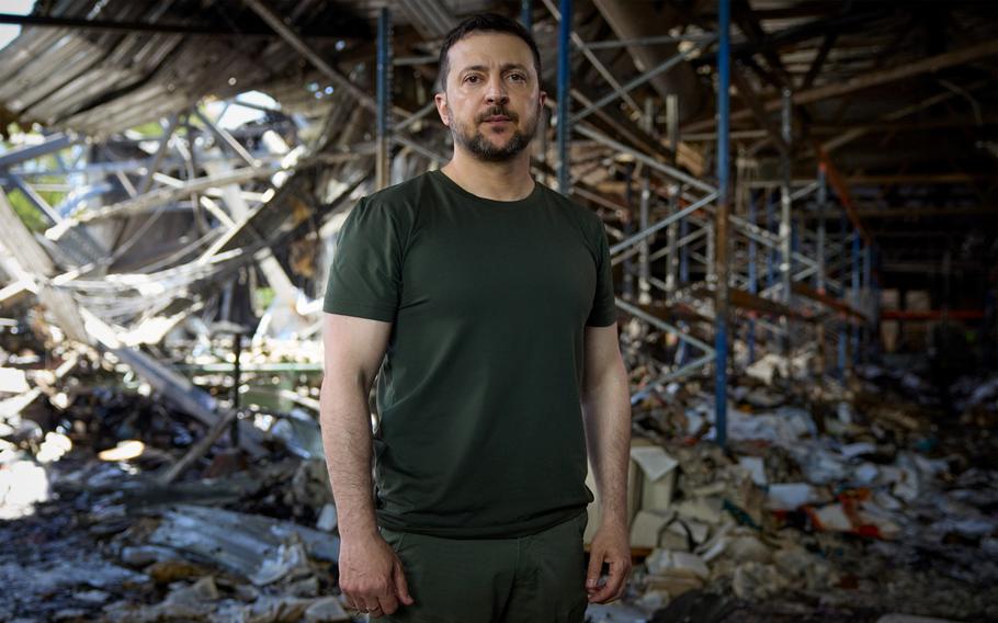 Ukraine President Volodymyr Zelenskyy stands inside a printworks compound, destroyed on Thursday in a Russian airstrike, on Sunday, May 26, 2024. 
