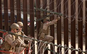 U.S. Marines install barbed wire along the border fence Friday, Jan. 31, 2025, in San Diego. (AP Photo/Jae C. Hong)