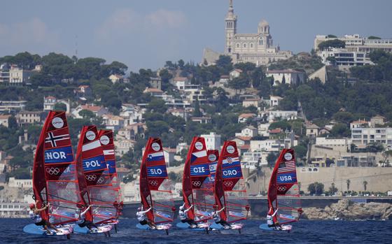 Competitors from Norway, Poland, Slovenia, the Czech Republic, Croatia, and the U.S. maneuver through the water during the women's windsurfing race at the 2024 Summer Olympics, Monday, July 29, 2024, in Marseille, France. 