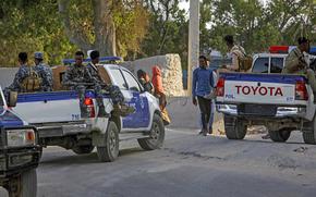 Somalia police patrol near the scene of a suicide bomber attack at a café, in Mogadishu, Somalia, Thursday, Oct. 17, 2024. (AP Photo/Farah Abdi Warsameh)