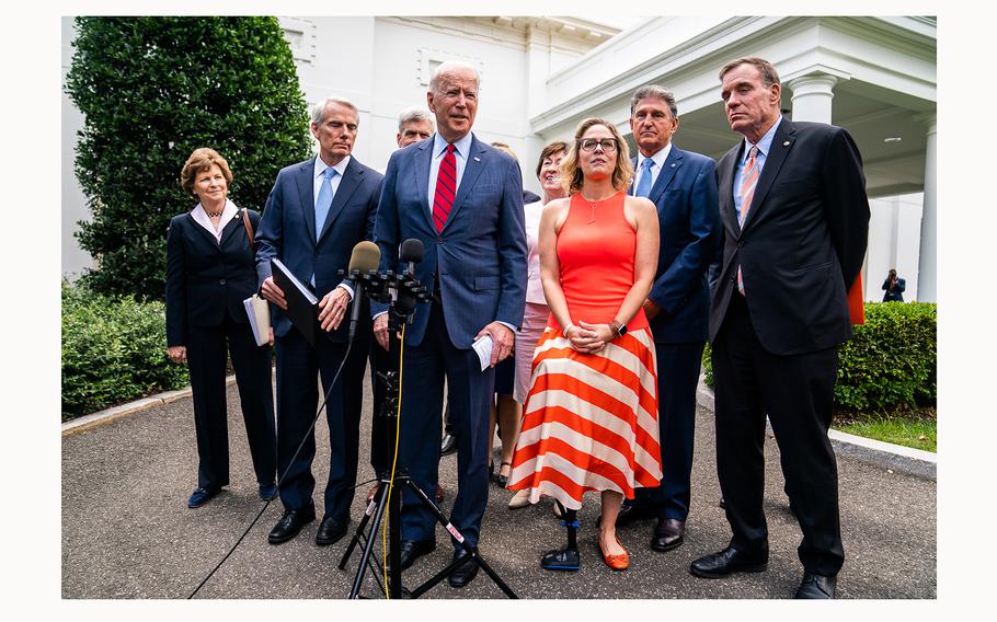 Sen. Mark Warner, at right, is seen at the White House with President Joe Biden and others. According to reports Friday, July 5, 2024, Warner is attempting to organize a group of Senate Democrats to ask Biden to step aside and exit the presidential race.