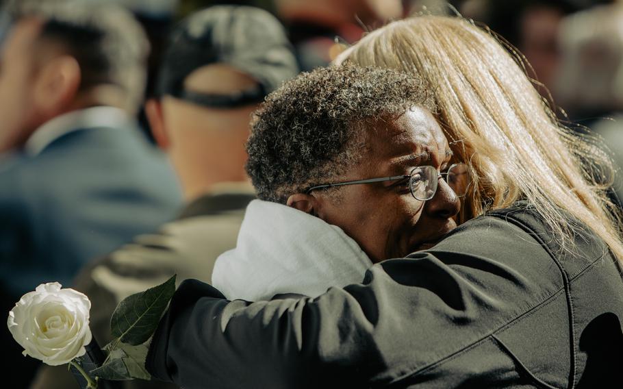 Thomasine Baynard, the spouse of Lance Cpl. James R. Baynard, a fallen communications specialist with 1st Battalion, 8th Marine Regiment, 2nd Marine Division, embraces a loved one following the 40th Beirut Memorial Observance Ceremony at Lejeune Memorial Gardens in Jacksonville, North Carolina, Oct. 23, 2023.