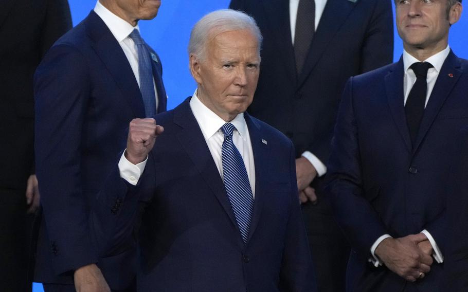 President Joe Biden pumps his fist as he poses with other NATO leaders Wednesday, July 10, 2024, for an official photo at the NATO summit in Washington. 