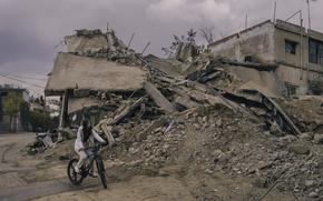 Aya rides her bike near the site of an Israeli airstrike in the city of Baalbek, Lebanon, on Nov. 2. (MUST CREDIT: Lorenzo Tugnoli for The Washington Post) 