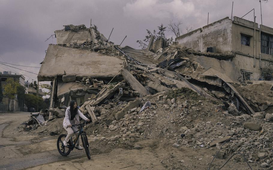 Aya rides her bike near the site of an Israeli airstrike in the city of Baalbek, Lebanon, on Nov. 2. 