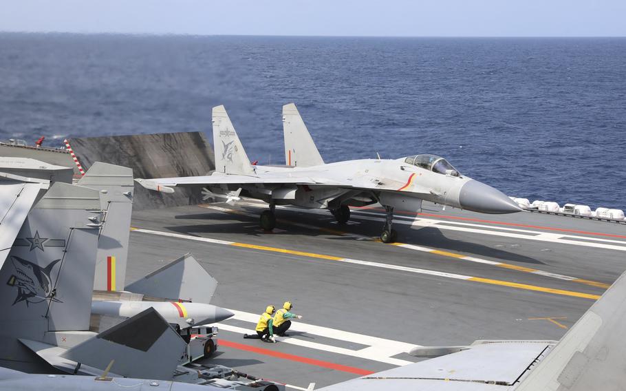 A J-15 Chinese fighter jet prepares to take off from an aircraft carrier.