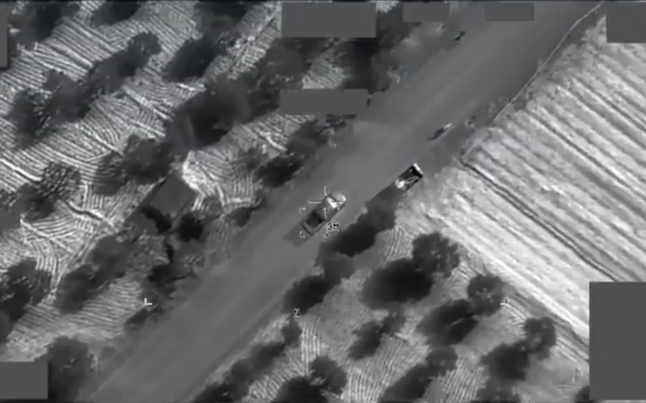 A gray and white image showing a precision airstrike from an aerial view.