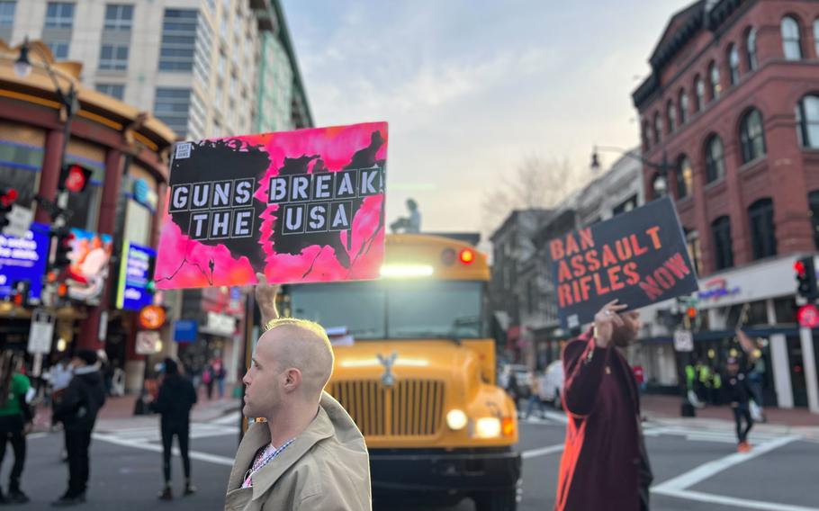 People stand in an intersection to call for stronger gun control earlier this year in Washington. A Pew Research Center poll showed more Americans, identifying with both parties, view gun violence as a significant problem.