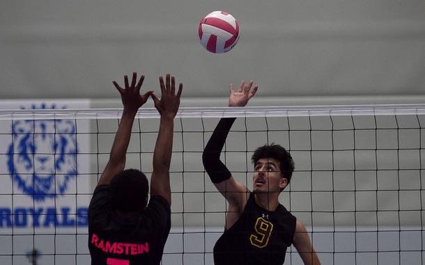 Vilseck's Rohail Jan dinks the ball over Ramstein blocker Nate Levingston during an Oct. 19, 2024, match at Ramstein High School on Ramstein Air Base, Germany.