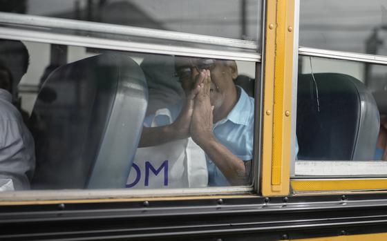 Isaias Ruiz gestures from a bus after being released from a Nicaraguan jail and landing at the airport in Guatemala City, Thursday, Sept. 5, 2024. (AP Photo/Moises Castillo)