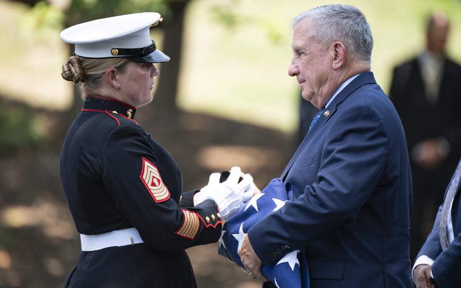 U.S. Marine Corps Master Gunnery Sgt. Stacie Crowther presents the shell casing from the funeral firing party to U.S. Marine Corps retired Lt. Gen. George Flynn following the funeral service for retired Gen. Alfred Gray Jr. at Arlington National Cemetery, Arlington, Va., July 29, 2024. Gray was interred that day with his wife, Janie Ann Gray. Flynn received the U.S. flag as Gray and his wife had no surviving family.