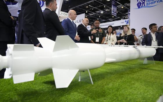 Philippine military chief Gen. Romeo Brawner Jr. center, listens as an exhibitor explains the Wind Demon, a long range air to surface cruise missile, during the Asian Defense and Security Exhibition on Wednesday, Sept. 25, 2024, in Manila, Philippines.