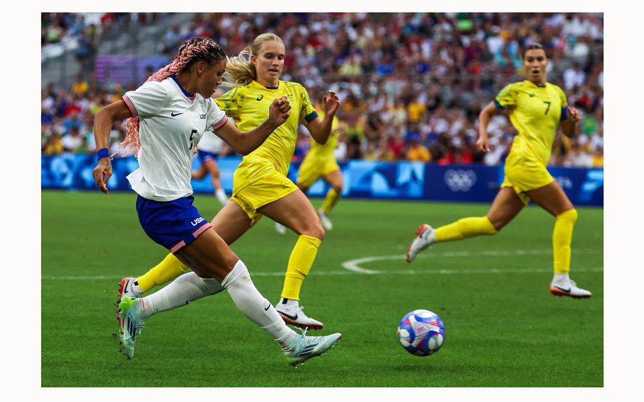 US’ forward (5) Trinity Rodman kicks the ball past Australia’s midfielder (3) Kaitlyn Torpey during the women’s group B football match between Australia and the USA of the Paris 2024 Olympic Games at the Marseille Stadium in Marseille on July 31, 2024. 