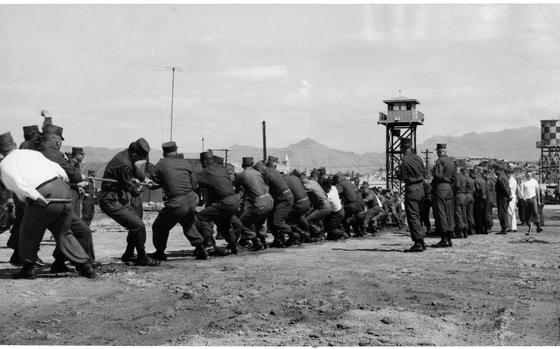 Camp Page, South Korea, Apr. 18, 1959: Tug of war contest between the 226th Signal Company and the 1st Missile Battalion was won by the Missilemen. Hq. and Hq. Company was second and 19th Infantry third. The 1st Missile Battalion also won the organizational day trophy for winning most of the individual events. 

The tug of war contest was one of the many events at the 4th Missile Command's first anniversary at Camp Page. Points were awarded in seven events in the day-long celebration. Apart from the tug-of-war, there also was a cake and cobbler baking contest, several drill team competitions, as well as a variety of truck rodeo events.

Looking for Stars and Stripes’ historic coverage? Subscribe to Stars and Stripes’ historic newspaper archive! We have digitized our 1948-1999 European and Pacific editions, as well as several of our WWII editions and made them available online through https://starsandstripes.newspaperarchive.com/

META TAGS: 4th Missile Command; competition; event; military life; servicemember; anniversary; celebration; sports; guard tower; spectators