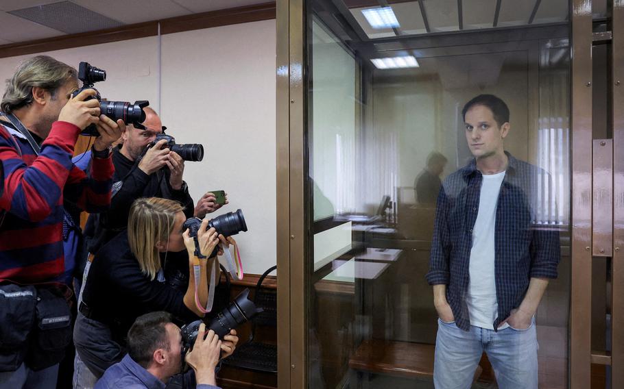 Wall Street Journal reporter Evan Gershkovich stands inside an enclosure for defendants before a court hearing to consider an appeal against his pre-trial detention on espionage charges in Moscow, Oct. 10, 2023. 