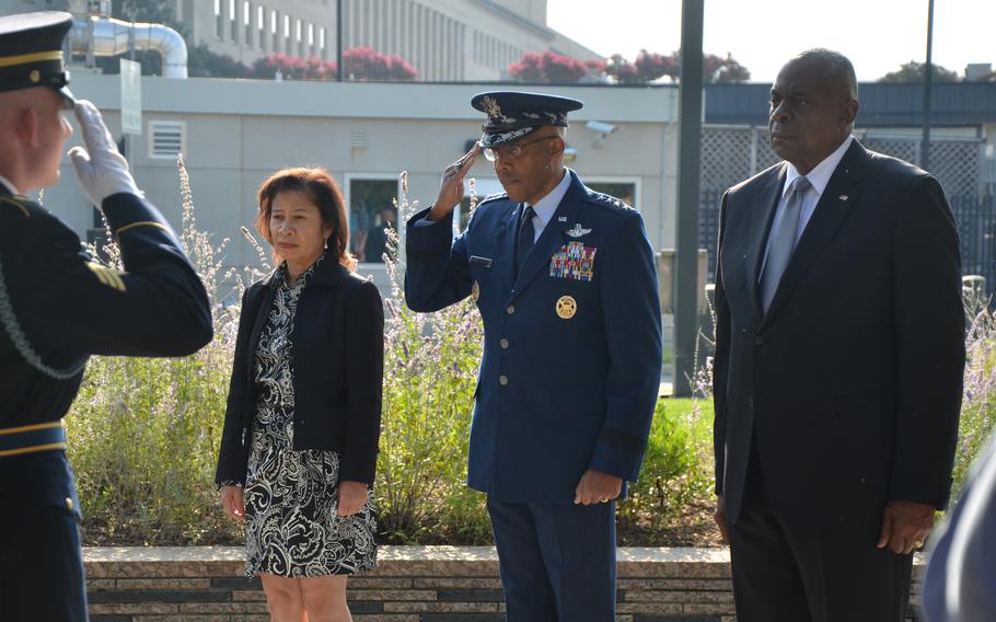 Air Force Gen. Charles “CQ” Brown, the chairman of the Joint Chiefs of Staff, center, his wife Sharene Brown, left, and Defense Secretary Lloyd Austin on Wednesday, Sept. 11, 2024, at a wreath-laying as part of a 9/11 observance ceremony.