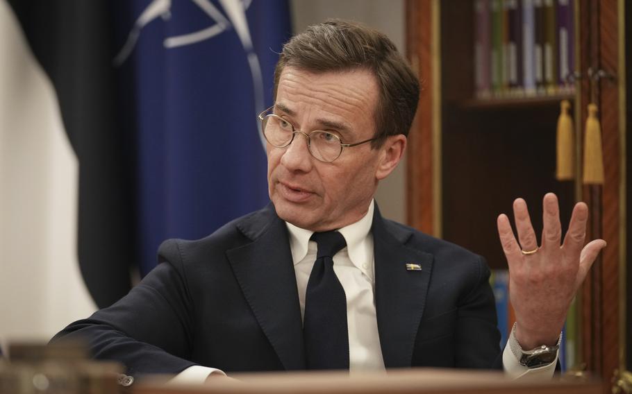 Ulf Kristersson gestures with his left hand during an interview with the Associated Press.