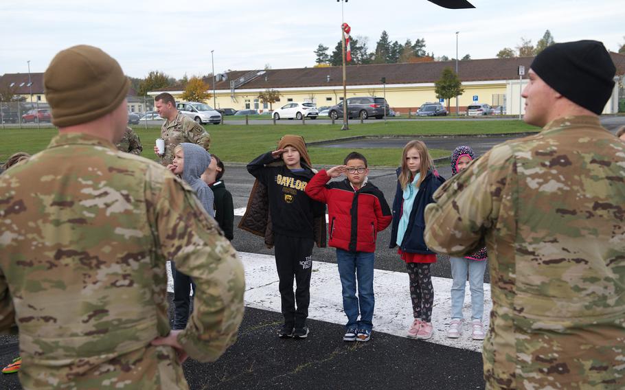 Grafenwoehr Elementary School salute soldiers during a presentation on medevac procedures.