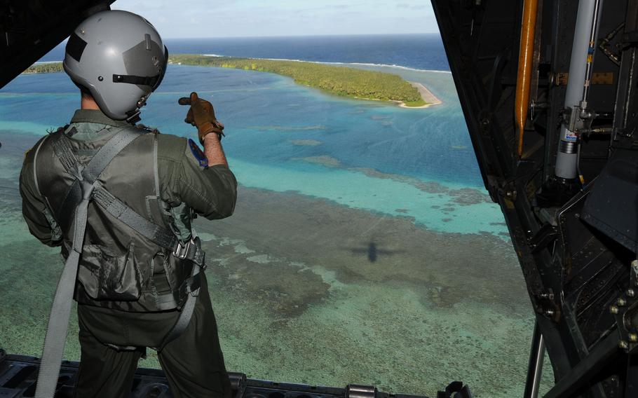 Senior Airman Benjamin Shest provides coordinates via radio