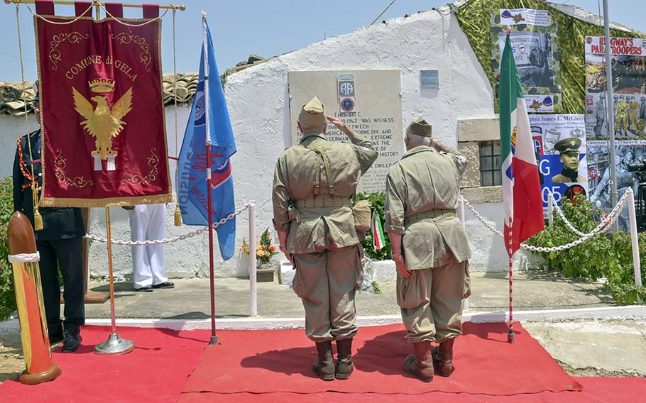 Italian war reenactors present commemorative wreaths at an Operation Husky 80th anniversary ceremony at the 82nd Airborne Division Monument at Ponte Dirillo in Gela, Italy, July 10, 2023. 