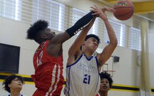 St. Mary's Caio Shiota (21) has the ball slapped away by Kinnick's Nicholas Whyte during Thursday's rematch of last year's Kanto Classic final. It was only a pool-play game this time, but the Red Devils avvenged that last-second loss to the Titans.