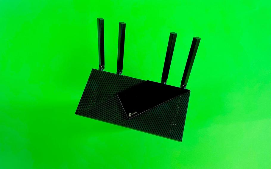 A black router is set on a lime green background.