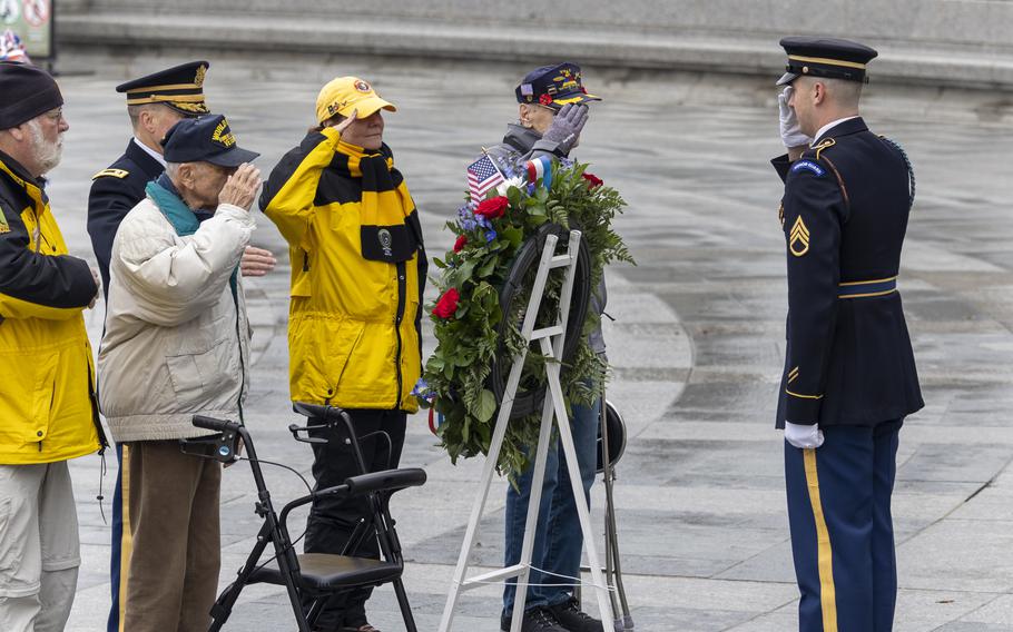 Veterans salute during ceremony.