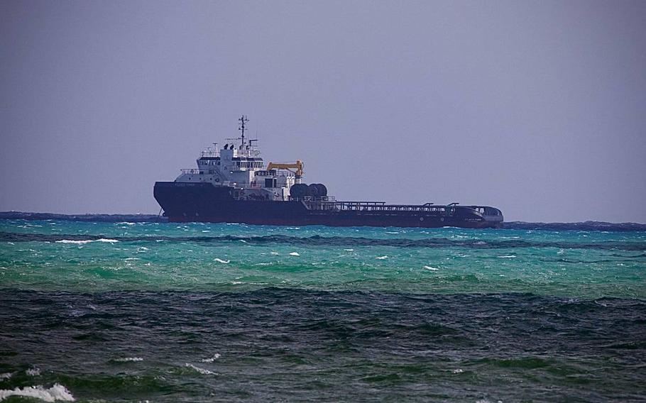 The Atlantic Power, a 250-foot anchor handling ship, floats idle off Government Cut in Miami Beach