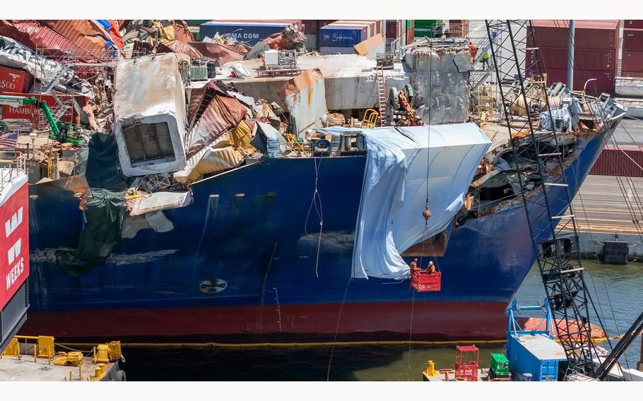 Salvage experts continue to clear the wreckage on the bow of the container ship Dali twelve weeks after the collapse of the Francis Scott Key Bridge. 