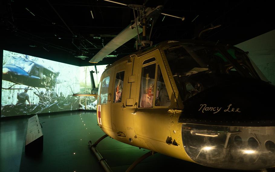 A helicopter in a dark room with digital displays in the background.