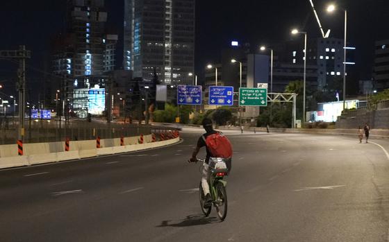 People walk or ride bicycles on an empty highway during the Jewish holiday of Yom Kippur in Tel Aviv, Israel, on Friday, Oct. 11, 2024. Yom Kippur or the Day of Atonement, which starts at sunset on Oct. 11, is the most sacred day of the Jewish calendar. (Sharon Aronowicz/AFP/Getty Images/TNS)