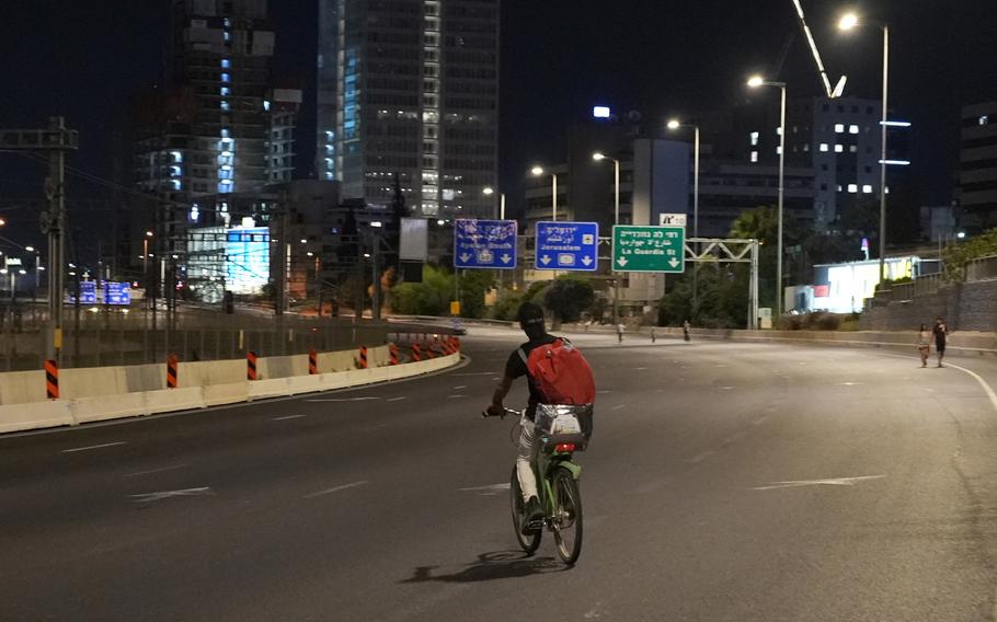 People walk or ride bicycles on an empty highway