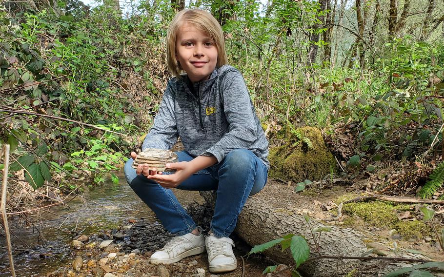 Jeremiah Longbrake, 9, with the mammoth tooth fragment he found on his grandmother’s property last month in Winston, Ore. 