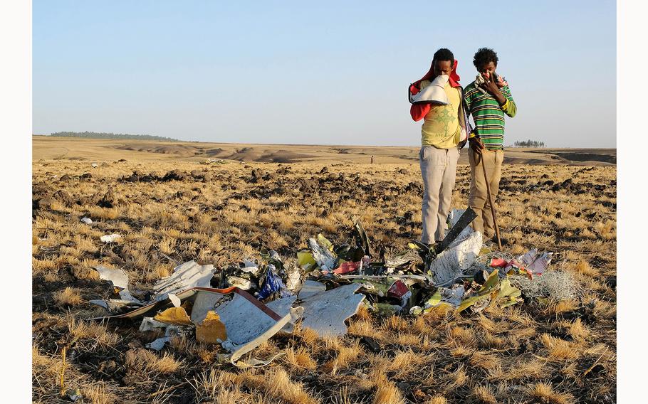 A pile of twisted metal is examined during a recovery effort at the crash site of Ethiopian Airlines flight ET302 on March 11, 2019, in Bishoftu, Ethiopia. 