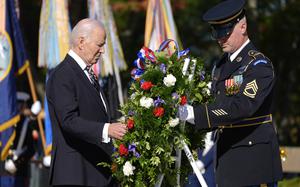 President Joe Biden, left, lays a wreath during a ceremony at the Tomb of the Unknown Soldier on National Veterans Day Observance at Arlington National Cemetery in Arlington, Va., Monday, Nov. 11, 2024. (AP Photo/Mark Schiefelbein)