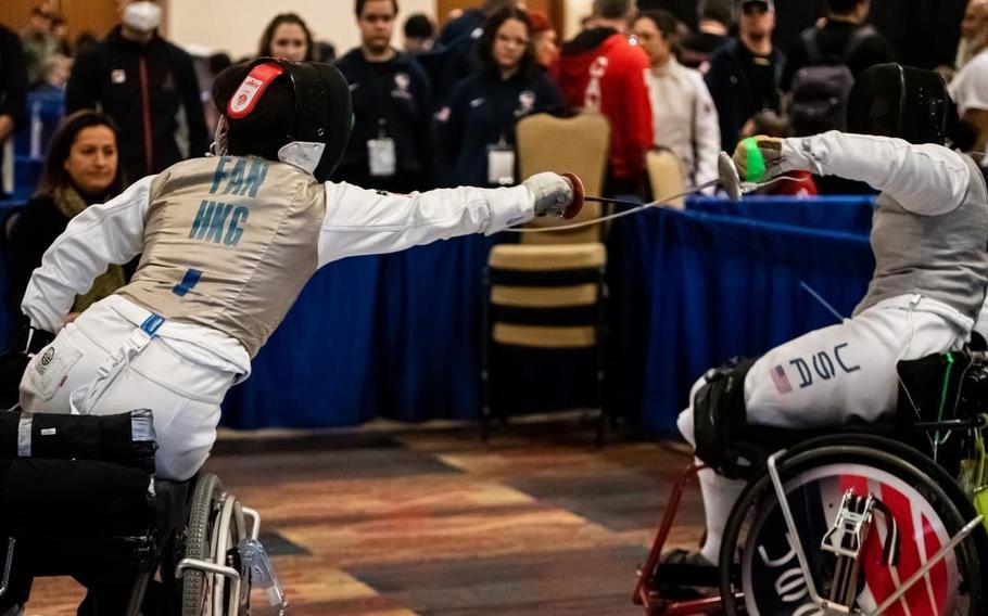 Taylor is shown competing against an athlete from Hong Kong in the 2023 Wheelchair Fencing World Cup, held in Washington, D.C. 