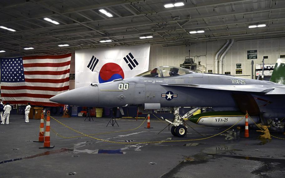 An F-18 fighter aircraft sits in the hanger of the Theodore Roosevelt, a nuclear-powered aircraft carrier, anchored in Busan Naval Base in Busan, South Korea Saturday, June 22, 2024. 